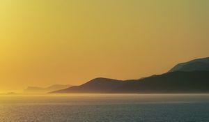 Preview wallpaper sea, hills, sunrise, landscape, nature