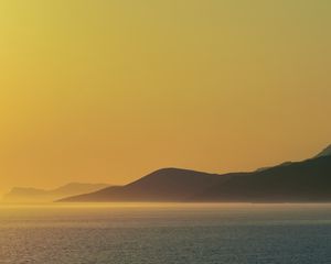 Preview wallpaper sea, hills, sunrise, landscape, nature