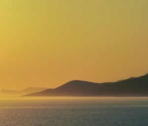 Preview wallpaper sea, hills, sunrise, landscape, nature