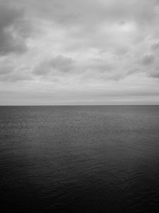 Preview wallpaper sea, horizon, bw, sky, clouds