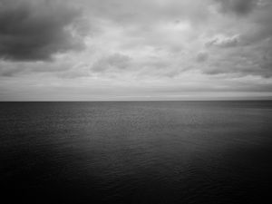 Preview wallpaper sea, horizon, bw, sky, clouds