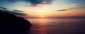 Preview wallpaper sea, horizon, tree, rock, silhouettes, sunset