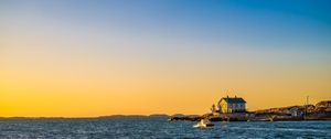 Preview wallpaper sea, houses, sky, sunset