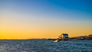 Preview wallpaper sea, houses, sky, sunset