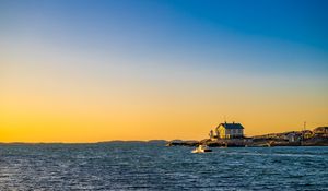 Preview wallpaper sea, houses, sky, sunset