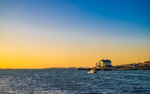 Preview wallpaper sea, houses, sky, sunset
