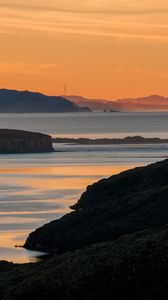 Preview wallpaper sea, islands, coast, silhouettes, sunrise