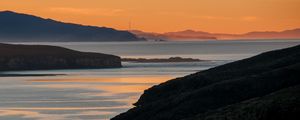 Preview wallpaper sea, islands, coast, silhouettes, sunrise