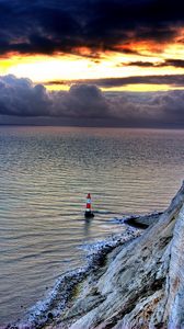 Preview wallpaper sea, lighthouse, rock, sunset