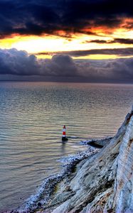 Preview wallpaper sea, lighthouse, rock, sunset