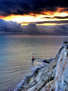 Preview wallpaper sea, lighthouse, rock, sunset