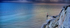 Preview wallpaper sea, lighthouse, rock, sunset