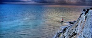 Preview wallpaper sea, lighthouse, rock, sunset