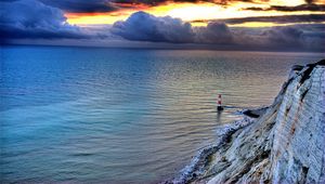 Preview wallpaper sea, lighthouse, rock, sunset