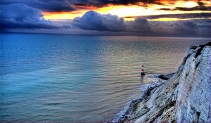 Preview wallpaper sea, lighthouse, rock, sunset