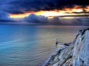 Preview wallpaper sea, lighthouse, rock, sunset