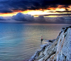 Preview wallpaper sea, lighthouse, rock, sunset