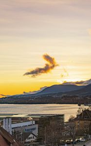 Preview wallpaper sea, mountains, buildings, sky, evening