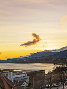 Preview wallpaper sea, mountains, buildings, sky, evening