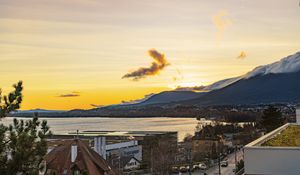 Preview wallpaper sea, mountains, buildings, sky, evening