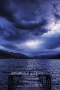 Preview wallpaper sea, mountains, evening, clouds, overcast, pier, scotland