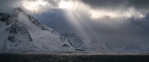 Preview wallpaper sea, mountains, snow, sunlight, clouds