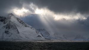 Preview wallpaper sea, mountains, snow, sunlight, clouds