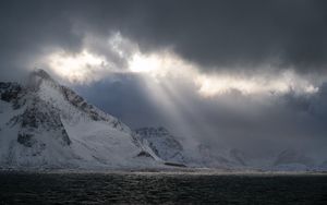 Preview wallpaper sea, mountains, snow, sunlight, clouds