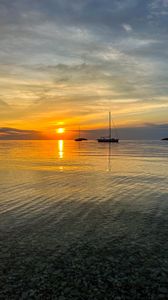 Preview wallpaper sea, pebbles, bottom, boats, sunset