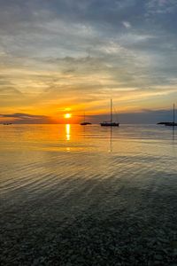 Preview wallpaper sea, pebbles, bottom, boats, sunset