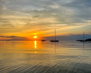 Preview wallpaper sea, pebbles, bottom, boats, sunset