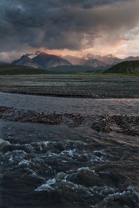 Preview wallpaper sea, pebbles, coast, hills, mountains, nature