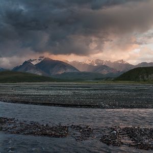 Preview wallpaper sea, pebbles, coast, hills, mountains, nature