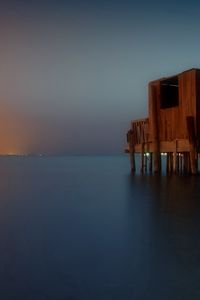 Preview wallpaper sea, pier, construction, wooden, surface, smooth surface, distance, fires