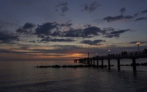 Preview wallpaper sea, pier, lights, clouds, sunset
