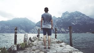 Preview wallpaper sea, pier, mountains, man, freedom