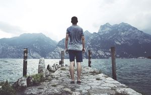 Preview wallpaper sea, pier, mountains, man, freedom