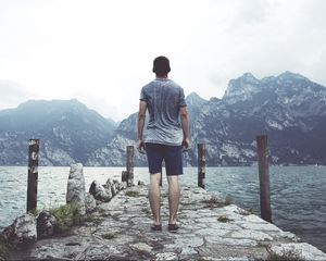 Preview wallpaper sea, pier, mountains, man, freedom