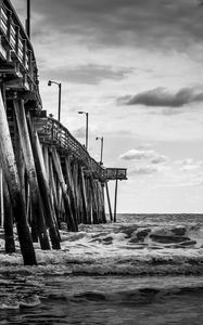 Preview wallpaper sea, pilings, pier, waves, black and white