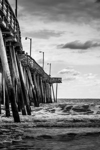 Preview wallpaper sea, pilings, pier, waves, black and white