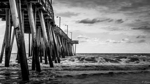 Preview wallpaper sea, pilings, pier, waves, black and white