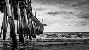 Preview wallpaper sea, pilings, pier, waves, black and white