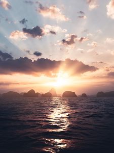 Preview wallpaper sea, rays, sun, rocks, sunset