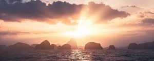 Preview wallpaper sea, rays, sun, rocks, sunset