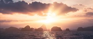 Preview wallpaper sea, rays, sun, rocks, sunset