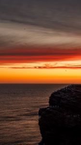 Preview wallpaper sea, rock, sunset, sky, dark, nature