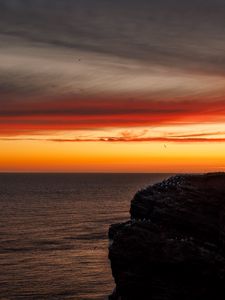 Preview wallpaper sea, rock, sunset, sky, dark, nature