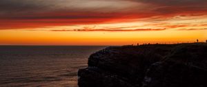 Preview wallpaper sea, rock, sunset, sky, dark, nature