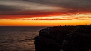 Preview wallpaper sea, rock, sunset, sky, dark, nature