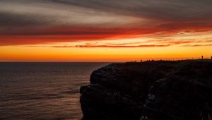 Preview wallpaper sea, rock, sunset, sky, dark, nature